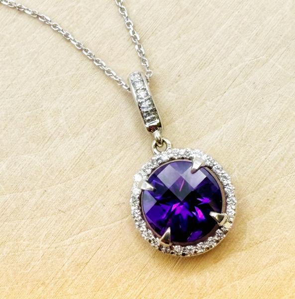14 karat white gold checkerboard cut amethyst and diamond necklace. $1,535.00