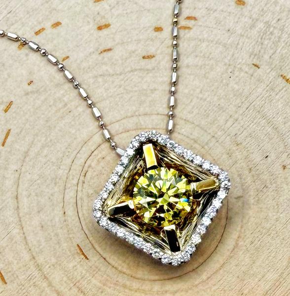 18 karat white and yellow gold, 1.78 carat Intense Yellow lab grown diamond fashioned in a custom designed reflection pendant with brilliant cut diamond accents. $3,800.00
