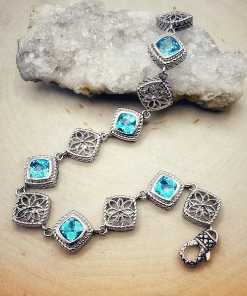 Sterling silver and cushion checkerboard cut blue topaz bracelet. $700.00