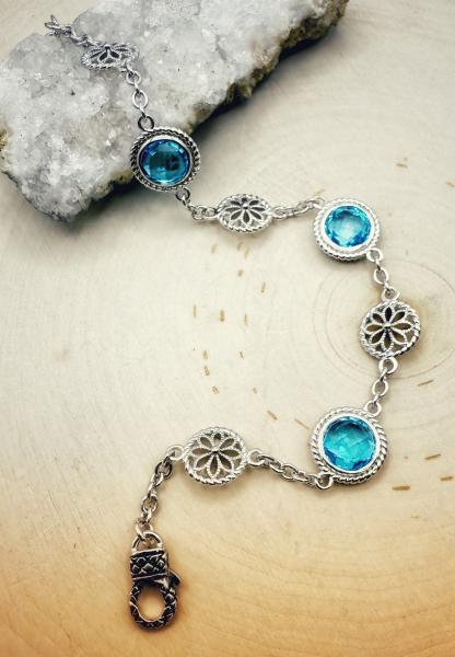Sterling silver round checkerboard cut blue topaz bracelet. $625.00