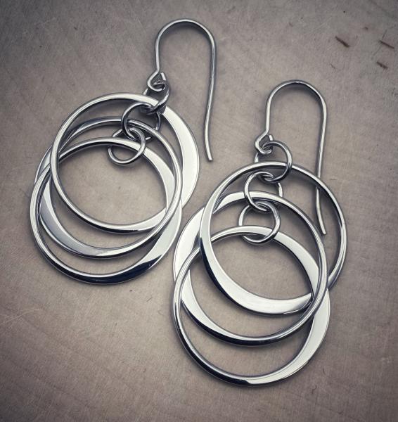 Sterling silver triple circle dangle earrings. $150.00