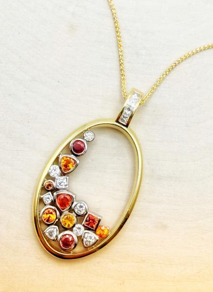 18 karat yellow and white gold re-orange sapphire and diamond necklace. $4,500.00