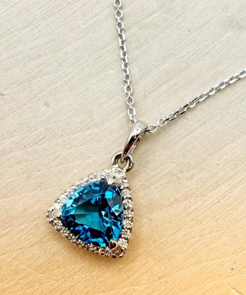 14 karat white gold 2.37 carat trillion cut London blue topaz and diamond necklace. $1900.00