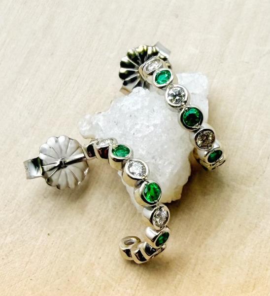 14 karat white gold emerald and diamond hoop earrings. $1190.00