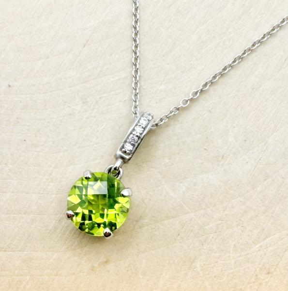 14 karat white gold round checkerboard cut peridot and diamond necklace. $1027.00