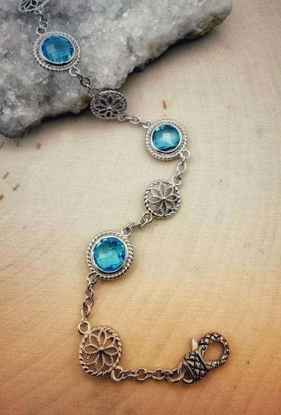 Sterling silver bracelet with round checkerboard faceted Swiss blue topaz. $550.00