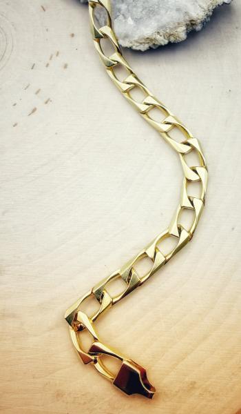 14 karat yellow gold, 8", 7mm wide solid square curb link bracelet. $3200.00