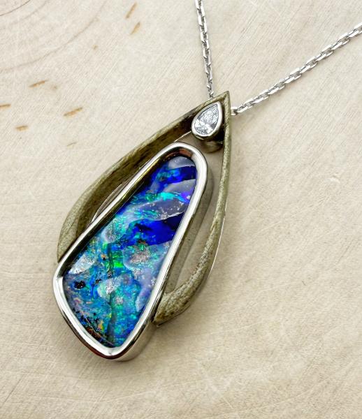 18 karat white gold boulder opal, diamond and carved burled chestnut necklace. $3,450.00