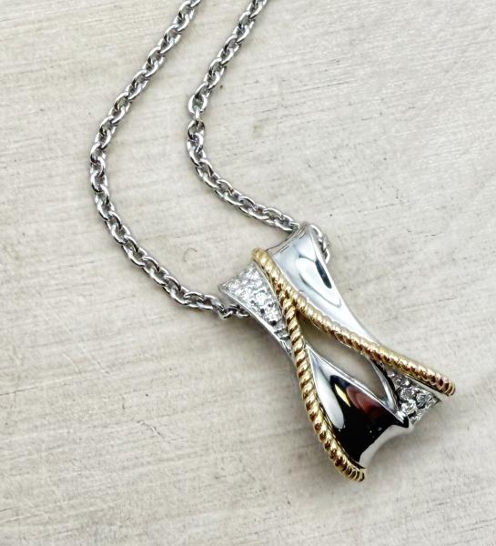 Sterling silver and 18 karat yellow gold diamond pendant and chain. $550.00