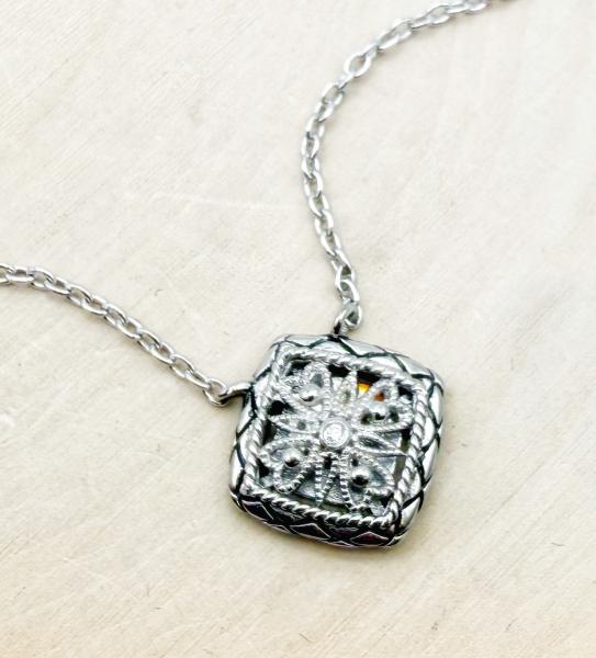 Sterling silver square filigree necklace with diamond accent. $150.00