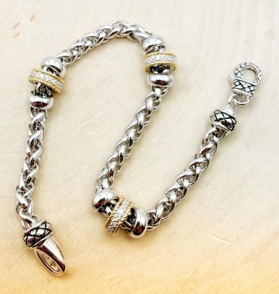 Sterling silver, 18 karat gold accent and diamond wheat link bracelet. $650.00