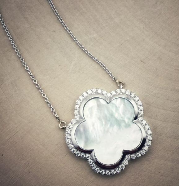 14 karat white gold mother of pearl and diamond clover necklace. $2970.00
