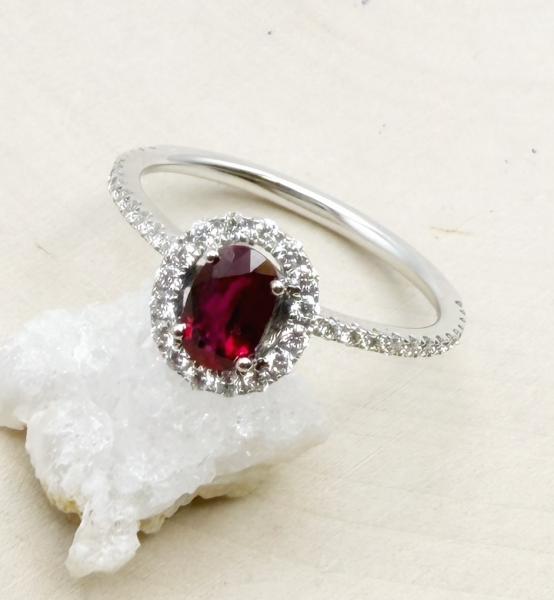 14 karat white gold ruby and diamond halo ring. $2550.00