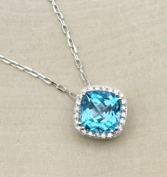 14 karat white gold cushion cut Swiss blue topaz and diamond halo necklace. $1480.00