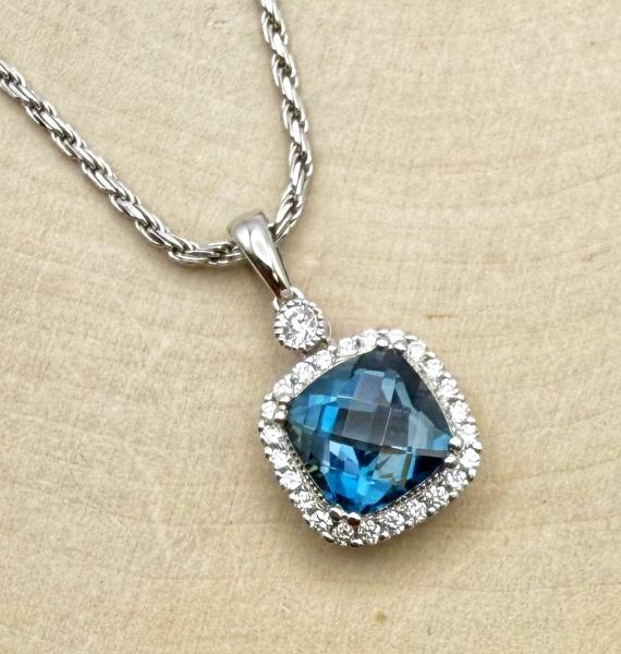 14 karat white gold cushion checkerboard cut London blue topaz and diamond necklace. $1550.00
