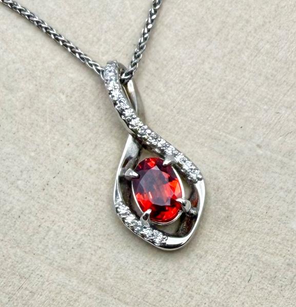 14 karat white gold re-orange sapphire and diamond necklace. $3020.00