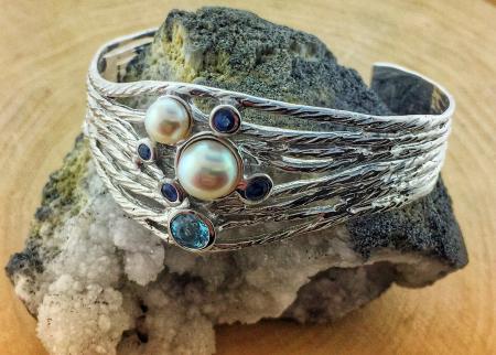 Sterling silver cuff bracelet with a blue topaz, fresh water pearls and blue sapphires. *sold*