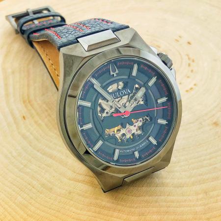 Gentlemen's Bulova with a skull design skeleton movement, gray stainless steel case. 21 jewel automatic movement with a 42 hour power reserve. $595.00