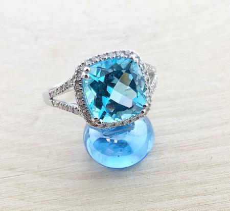 14 karat white gold ring with a 3.99 carat cushion blue topaz and diamond accents. *sold*