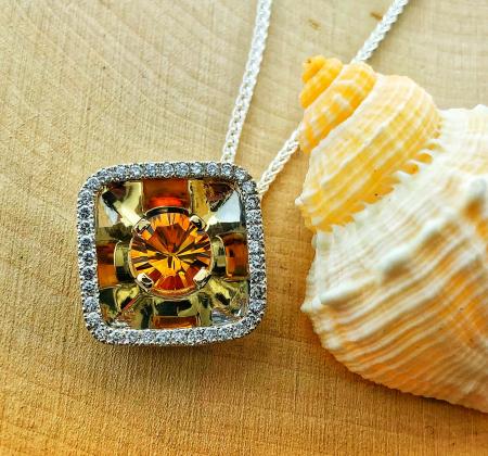 Sterling silver and 14 karat yellow gold citrine reflection pendant. $870.00