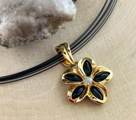 14 karat yellow gold black onyx and diamond flower necklace. $850.00