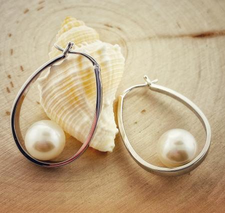 Sterling silver oval hoop earring with a 10mm cultured freshwater pearl. $295.00