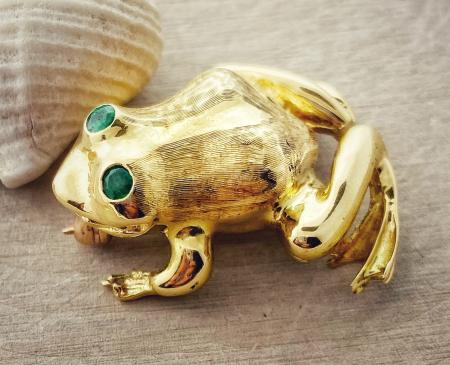 18 karat yellow gold, hand engraved frog brooch with 3mm emerald eyes. $2500.00