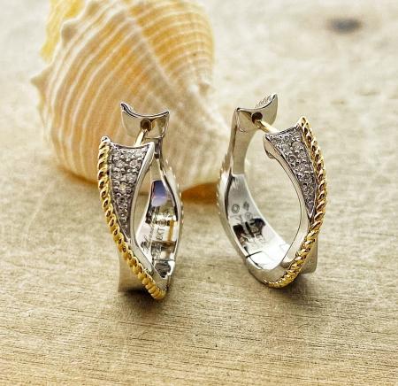 Sterling silver and 18 karat yellow gold diamond hoop earrings. $500.00