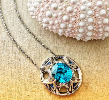 4.36 carat blue zircon adorned with Ceylon blue sapphires and brilliant cut diamonds. Fashioned in 18 karat white gold. $3250.00 *This item is sold and may be special ordered*