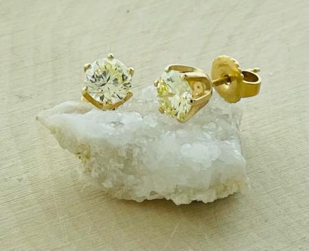 14 karat yellow gold 1.20ctw fancy light yellow diamond stud earrings. $2500.00