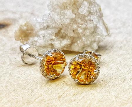 14 karat white gold 1.55ctw round citrines .07ctw diamond halo stud earrings. $590.00