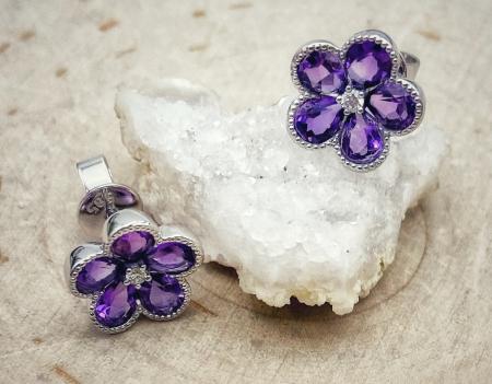 14 karat white gold flower 1.28ctw amethyst stud earrings with .03ctw accent diamonds.  $930.00