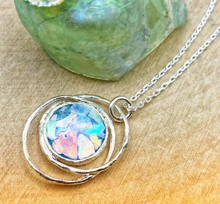 Sterling silver roman glass round free form orbit pendant on chain.  $140.00