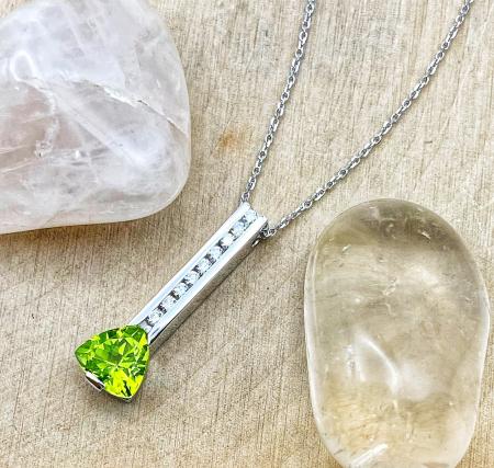 18 karat white gold trillion cut peridot and diamond bar necklace. $1050.00