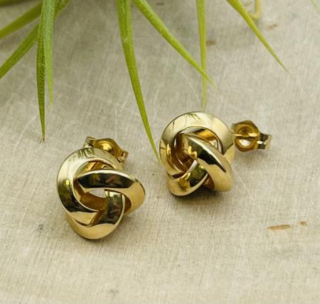 14k yellow gold love knot stud earrings. $275.00