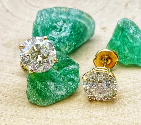 Diamond studs totaling 4.97 carats set in 14 karat yellow gold. $25,000.00