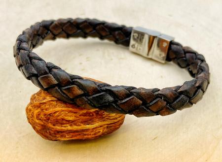 Brown woven leather bracelet with a stainless steel clasp. $120.00