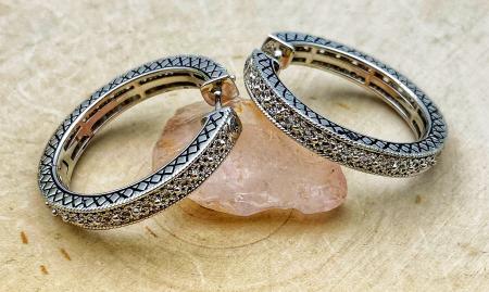Sterling silver filigree hoop earrings. $150.00