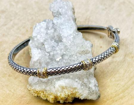 Sterling silver and 18 karat gold diamond bangle bracelet. $700.00