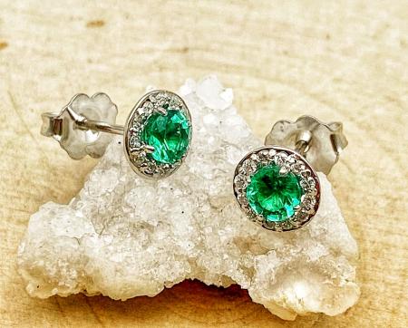 14 karat white gold emerald and diamond halo earrings. $1600.00