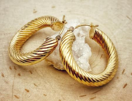 14 karat yellow gold twist style hoops. $465.00