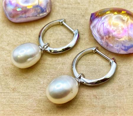 Sterling silver pearl drop hoop earrings. $165.00