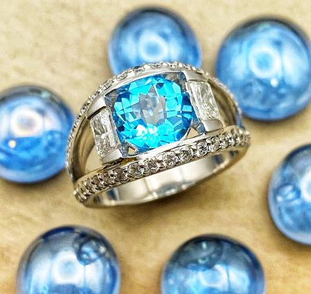 18 karat white gold 2.50 carat Swiss blue topaz, brilliant cut and radiant cut diamond ring. $3750.00 **Just Sold**