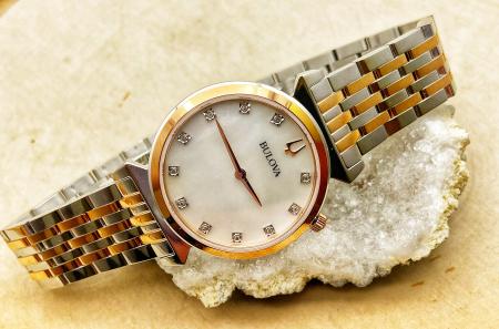 Ladies Bulova stainless steel watch, rose gold two tone, mother of pearl face, diamond markers. $495.00