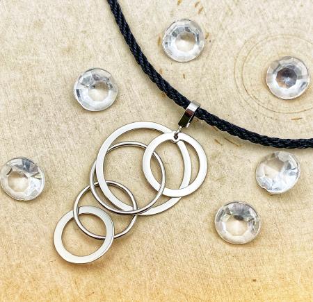 Sterling silver multi ring dangles pendant on silk 18" cord. $160.00  