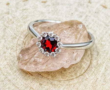 14 karat white gold ring with a  0.53 carat garnet and a diamond halo. $770.00