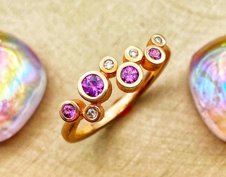 14 karat rose gold purple garnet and diamond ring. $1310.00