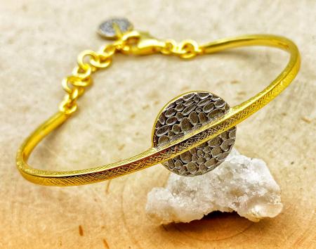 Sterling silver, 18 karat gold vermeil textured disc cuff bracelet. $390.00