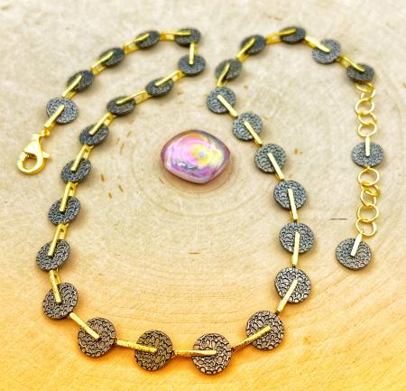 Sterling silver, 18 karat gold vermeil and ruthenium necklace. $800.00