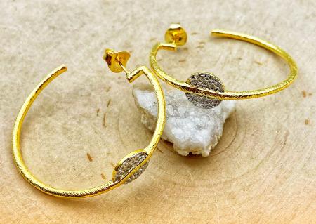 Sterling silver and 18 karat gold vermeil textured disc hoop earrings. $220.00